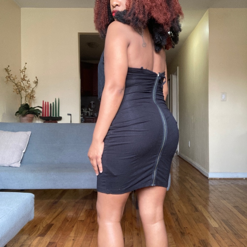 Black backless dress with fringe around chest
